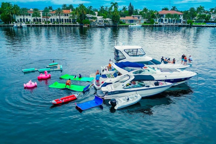 a group of people riding on the back of a boat in the water